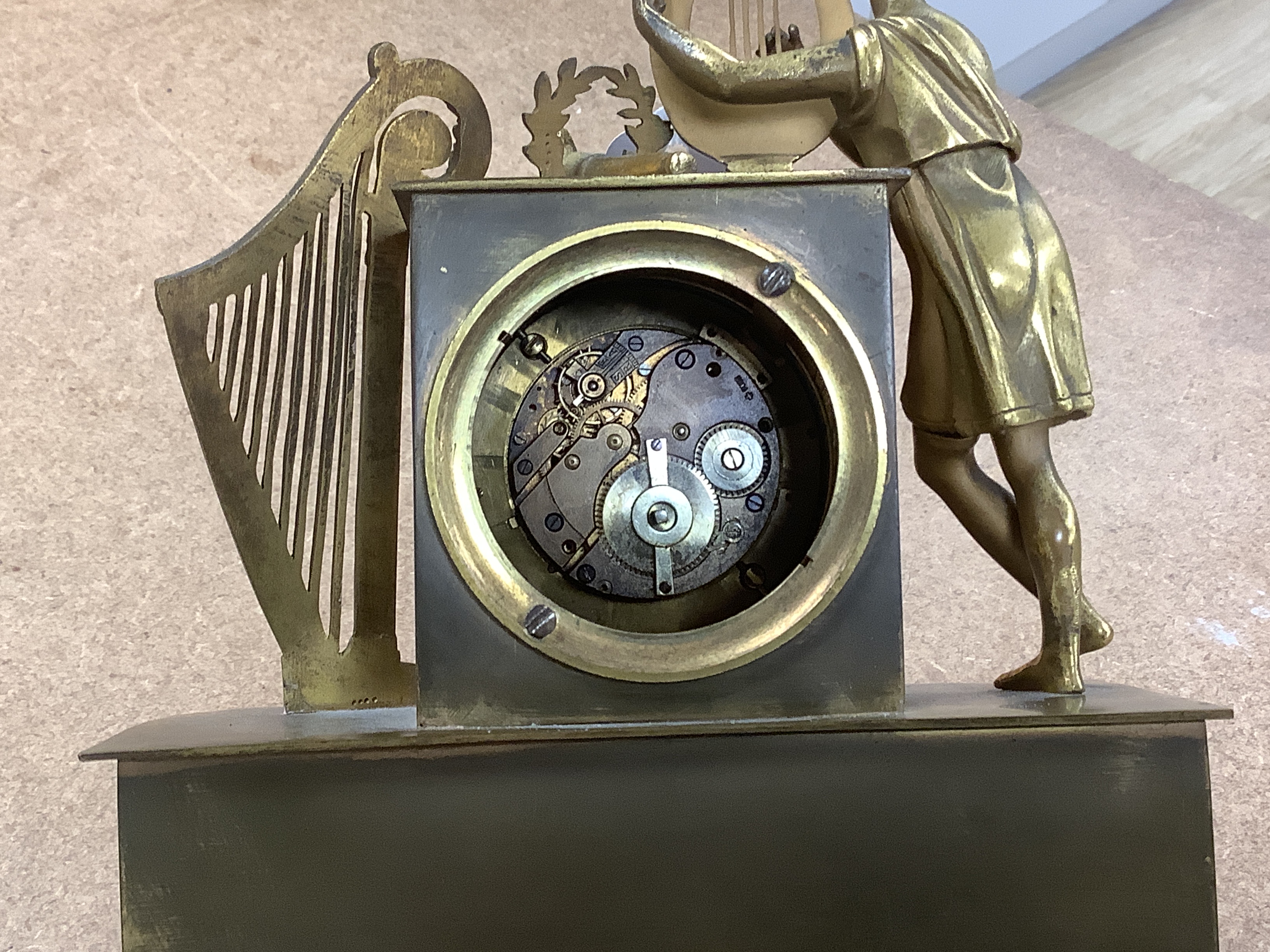 A 19th century French musical mantel timepiece, the dial inscribed Albert A Paris, the mahogany base with music box movement, 29cm high